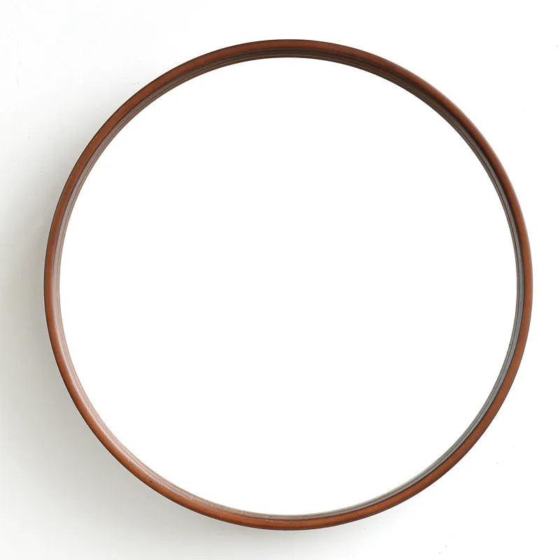 Round walnut-coloured solid wood hanging mirror with 30cm diameter and silvered glass
