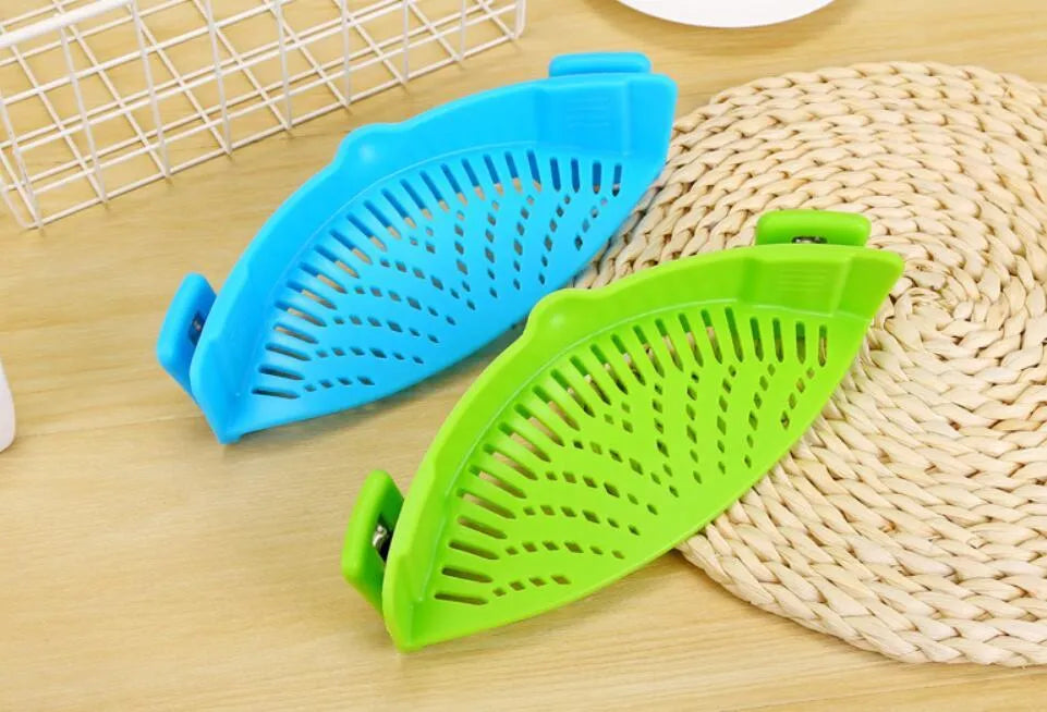 Silicone clip-on kitchen strainer with stainless steel mesh attached to pot rim for draining liquids