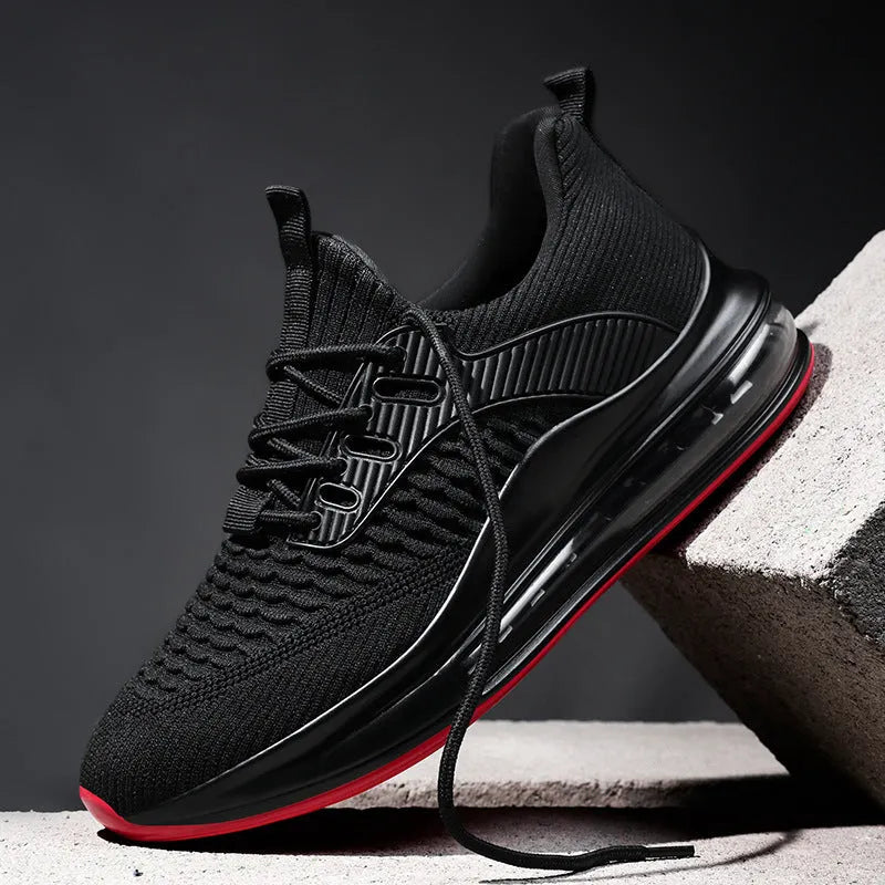 Black low-top mesh running sneakers with rubber sole, showing breathable construction and lace-up front