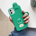 Green silicone iPhone case with cartoon animal design showing raised edges and precise port cutouts for charging and audio