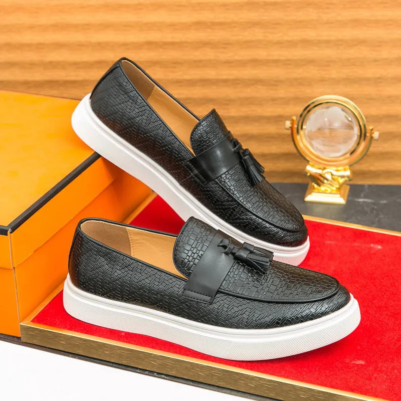 Men's black casual leather shoes with fringe detail on the upper and a low heel.