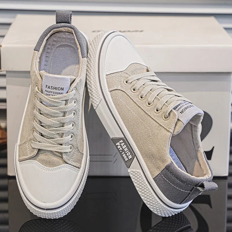 Men's low-top blue canvas shoes with round toe and white stitching on a soft PVC sole.