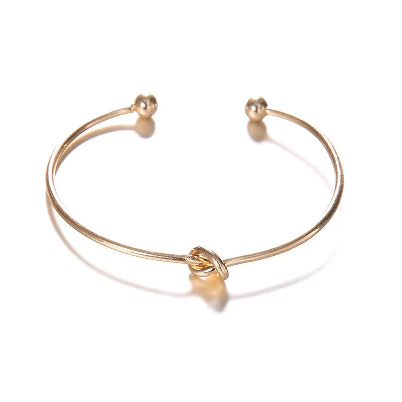 Women's vintage cuff arrow knotted bracelet with 2.5cm width and electroplated gold finish