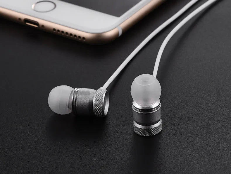Black, gold, pink, and silver coloured in-ear headphones with a 3.5mm plug.