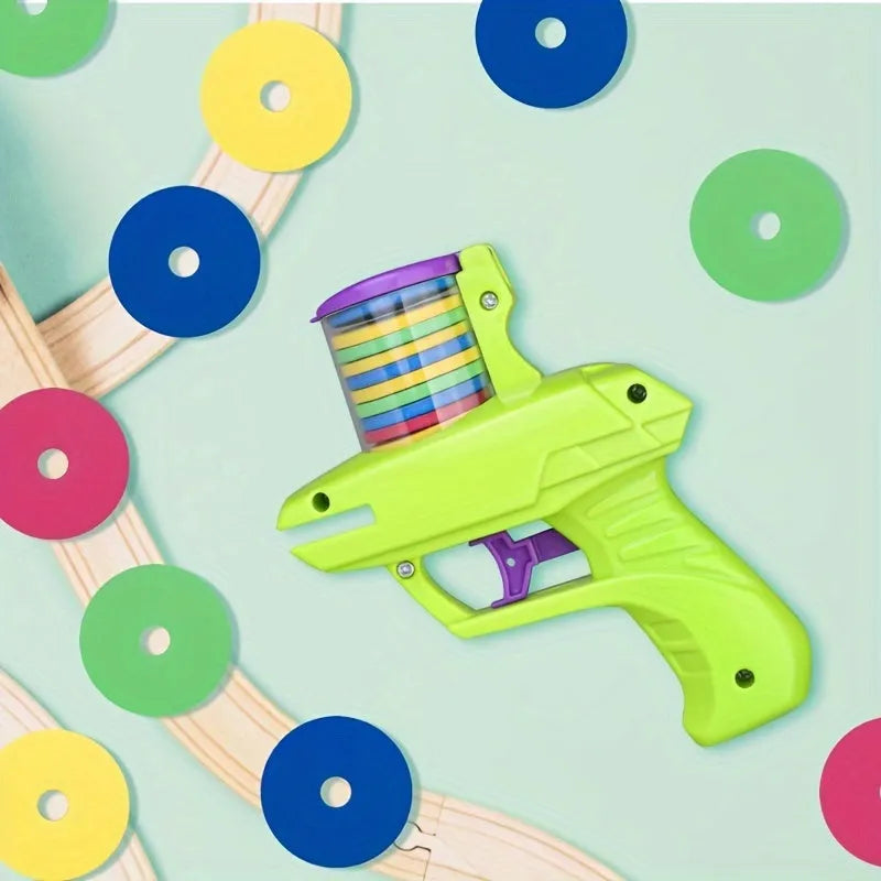 Green interactive cat toy launcher with foam discs on wooden floor