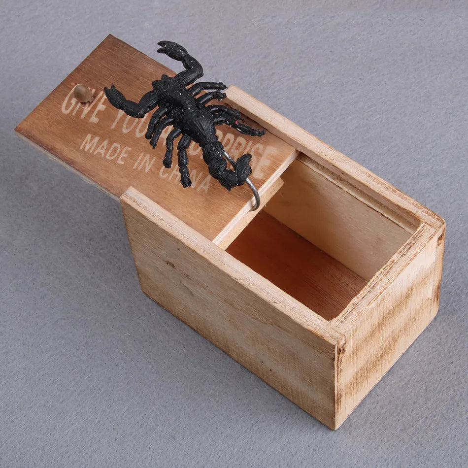 Wooden prank scare box closed, dimensions 9.1cm x 6.1cm x 6.5cm, for April Fools' jokes.