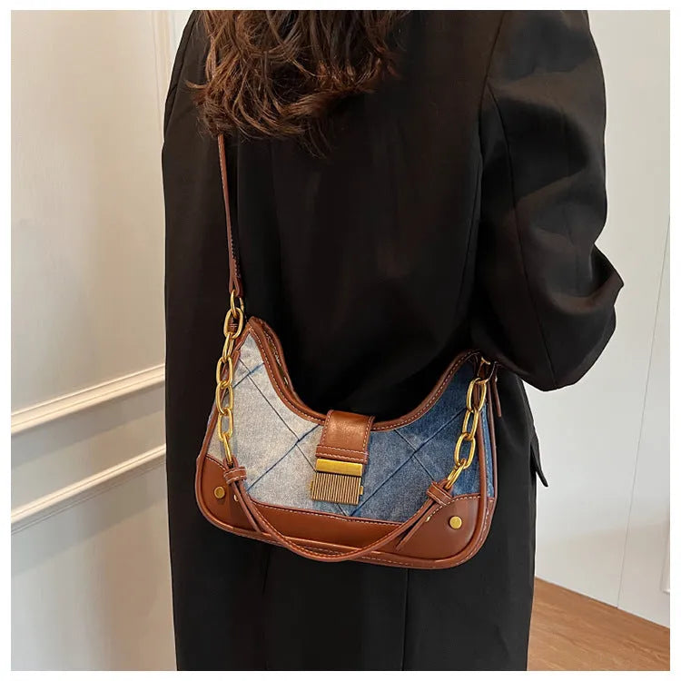 Brown denim women's bucket shoulder bag with diamond mesh detail, chain accents, and double adjustable straps