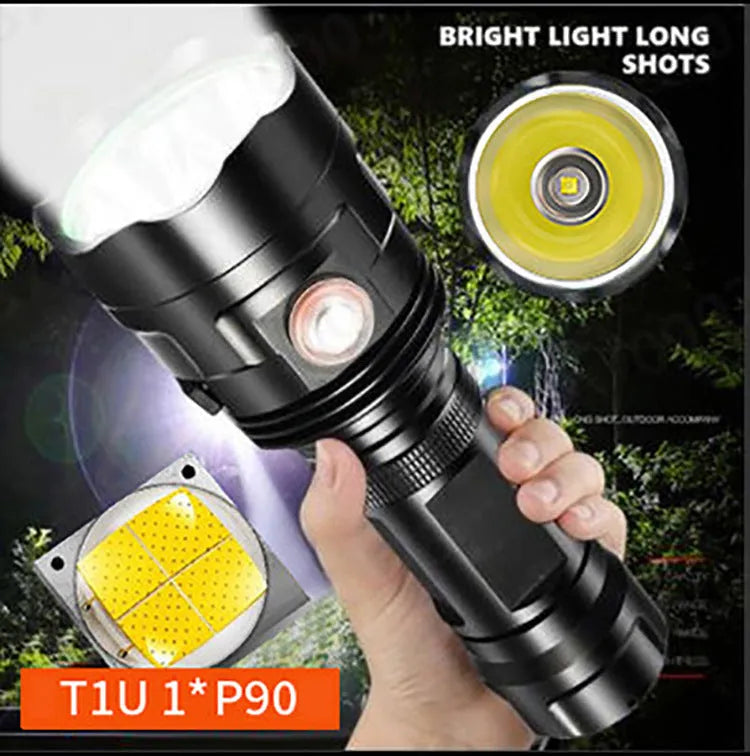 Black aluminium XHP90 LED tactical flashlight showing its size next to a USB charging cable.