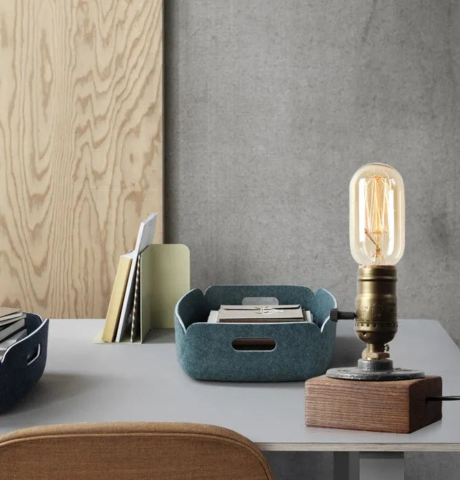 Water pipe table lamp with wood and iron construction, 9 cm wide and 13 cm tall, on a bedside table