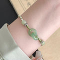 Green jade double ring strap bracelet with peace buckle and animal zodiac design in electroplated copper