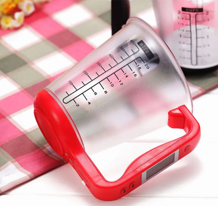Green electronic scale measuring cup with integrated LCD display showing weight and temperature readings