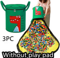 Green felt storage cube with pull rope, unfolded as a play mat on a living room floor
