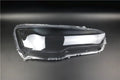 Transparent plastic automotive headlight housing cover showing clear construction