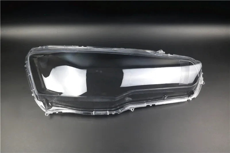Transparent plastic automotive headlight housing cover showing clear construction