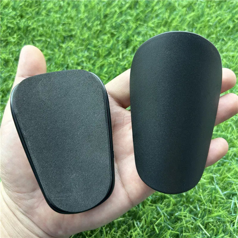 Extra small mini football shin guards in black and white measuring 8x5cm