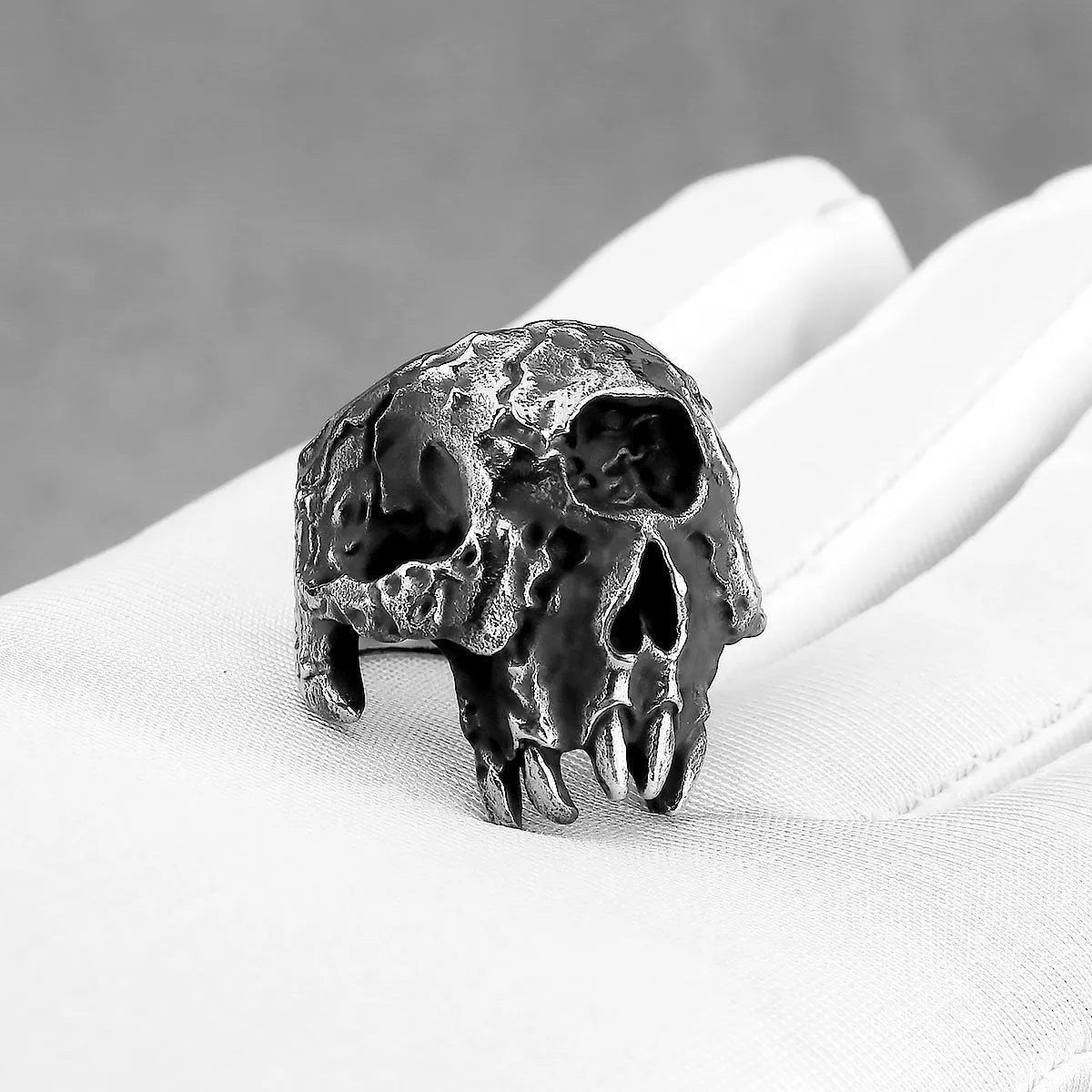 Alloy skull ring with one-eyed design and electroplated finish, shown in UK sizes 7-13 for retro punk style