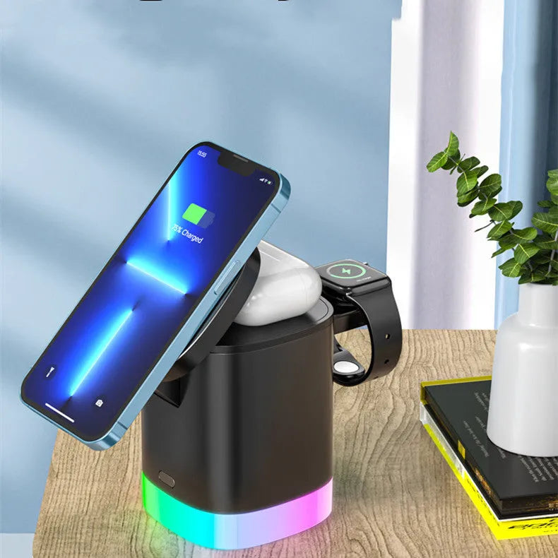 Black 3 in 1 magnetic wireless charging cube showing iPhone, Apple Watch and AirPods charging simultaneously with RGB lights