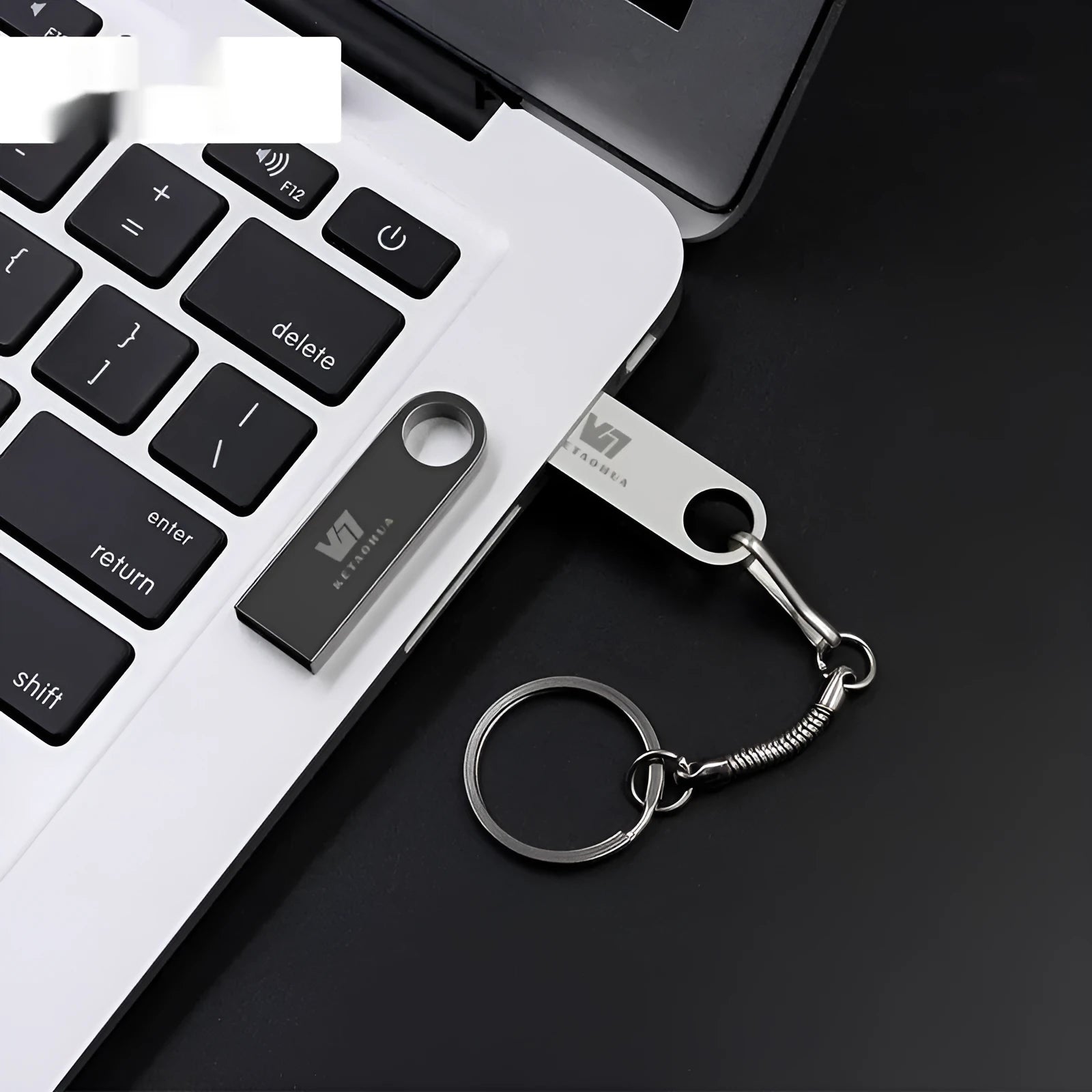Silver metal USB flash drive shaped like a car on a black background.