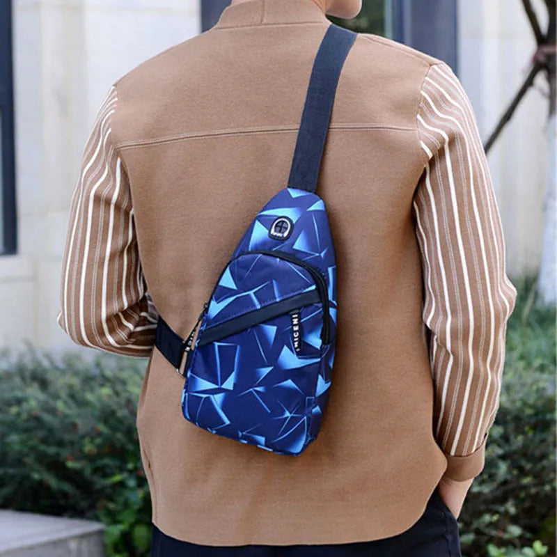 Men's crossbody chest sling bag in blue with earphone hole, zipper pockets, and soft handle, measuring 17x30x5cm