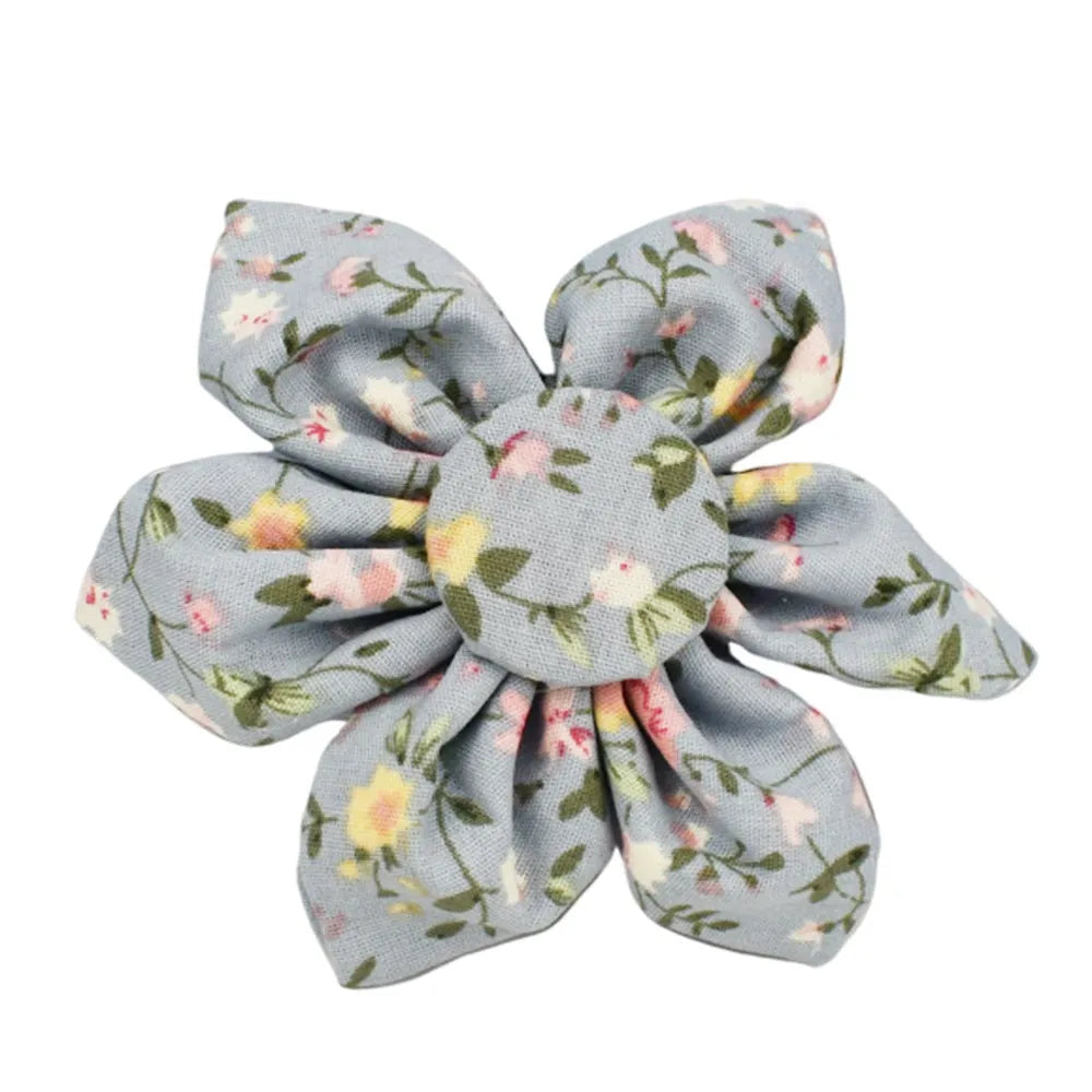Blue floral pattern dog collar set with matching leash, vest, bow, and poop bag holder on wooden background