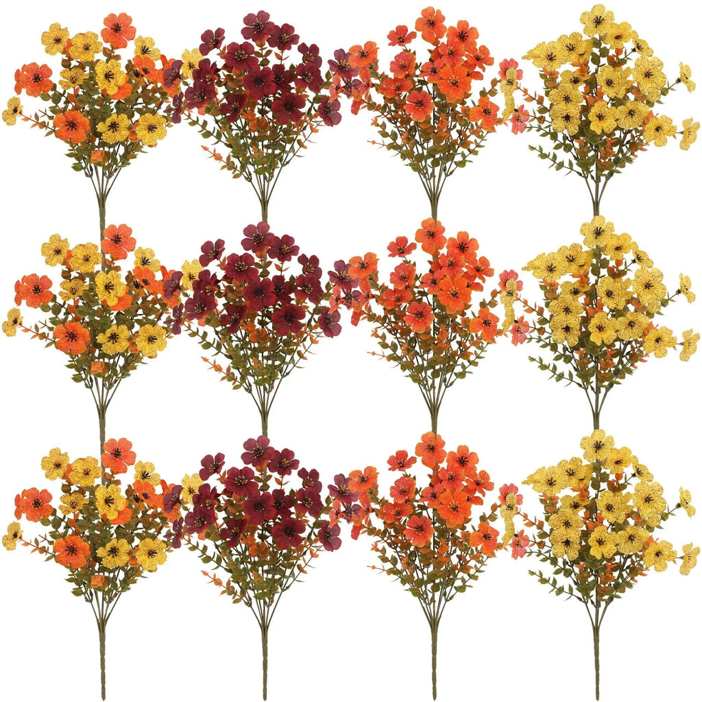 Artificial flower bouquet in autumn colours of red, yellow, and orange for home and event decoration.