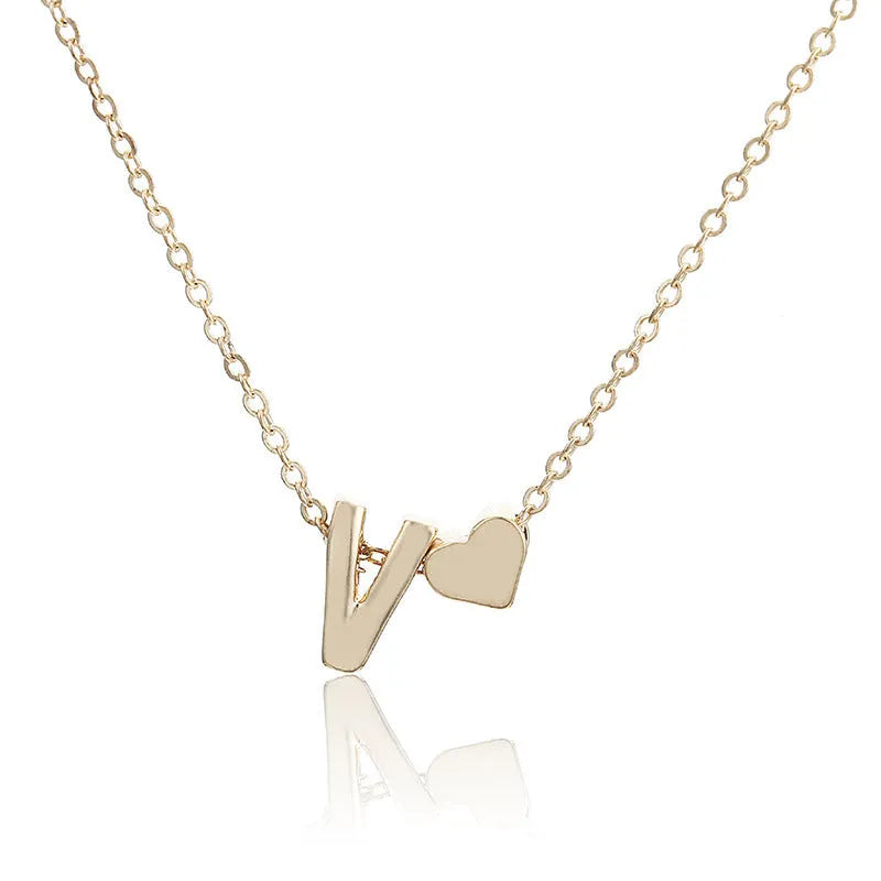 Peach heart shaped letter necklace pendant in gold or silver alloy, weighing 5.5g.