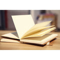 Brown kraft paper sketchbook and white paper sketchbook in 16K and 32K sizes, showing flat wireless binding.