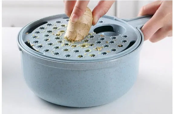 Blue hand-held mandoline slicer with stainless steel blades and plastic container for vegetable preparation