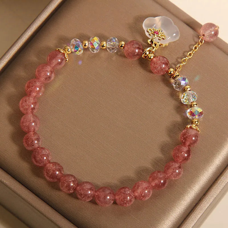 Women's strawberry quartz and white agate crystal bracelet with auspicious clouds charm.