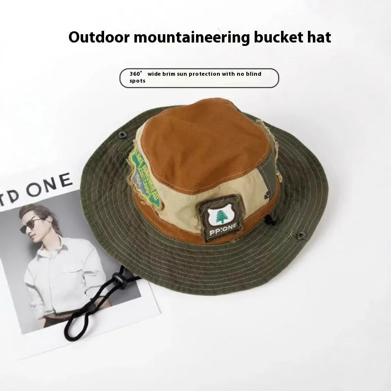 Army green cotton fisherman hat with hand-painted patchwork on flat top crown, folded for storage