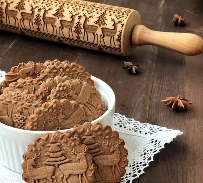 Solid wood rolling pin with embossed Christmas reindeer pattern on a 45cm long shaft.