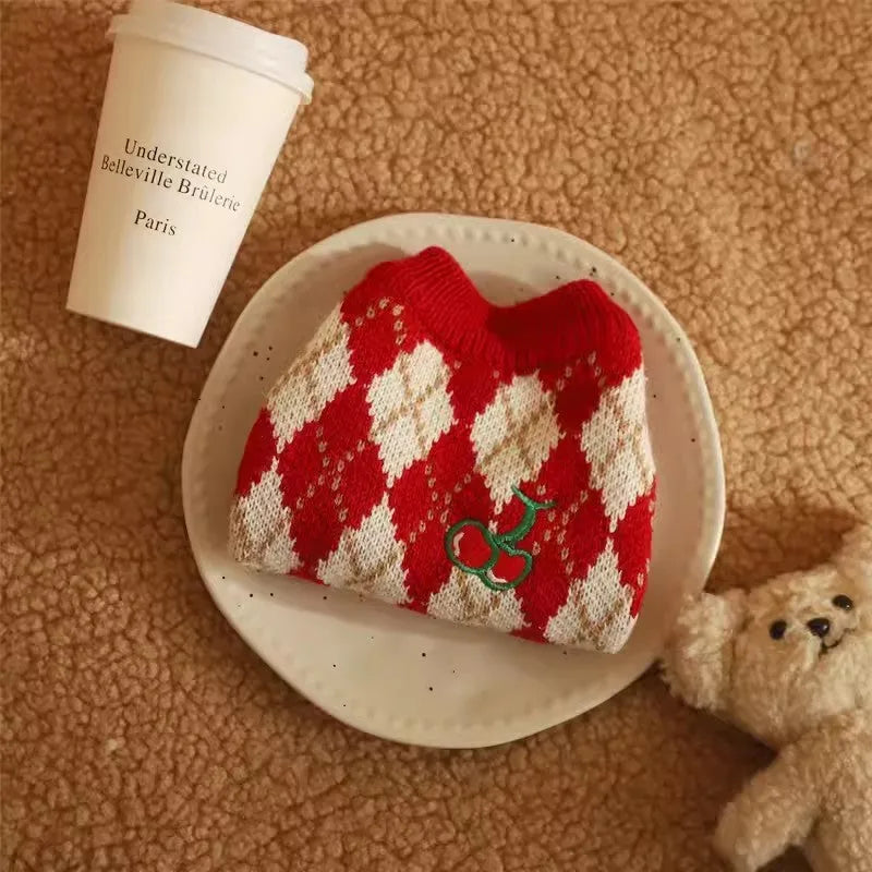Red cat sweater with rhombic cherry embroidery for autumn and winter wear, shown in casual style