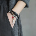 Ethnic black crystal bracelet with white tassels and elastic lacing in four sizes for boys and girls