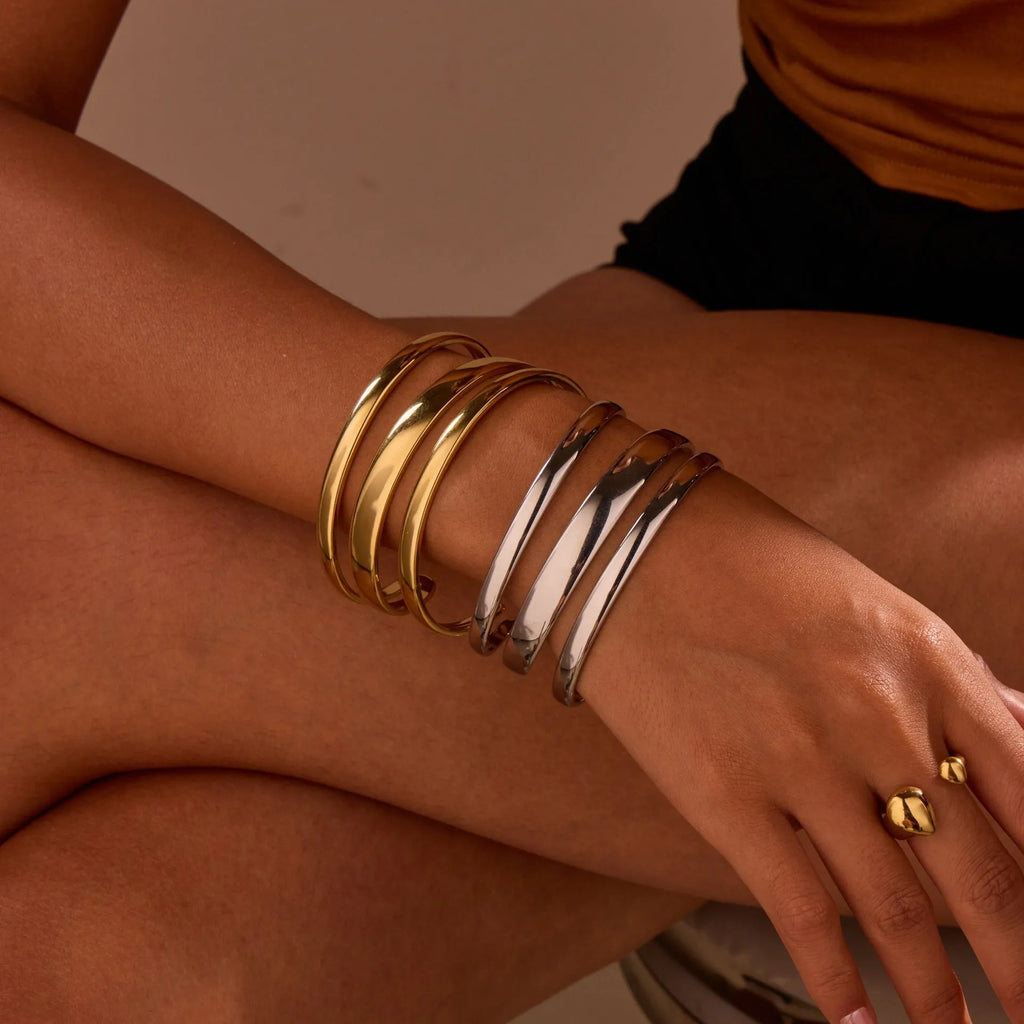 Stainless steel simple opening bracelet with geometric line design in gold or steel electroplated finish