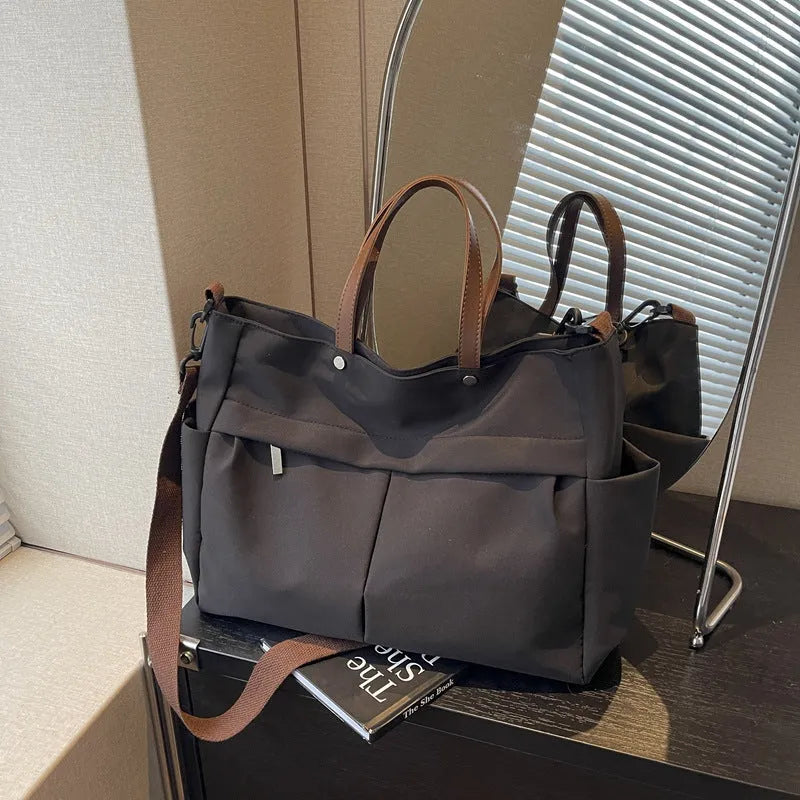 Nylon crossbody tote bag with shoulder strap in black, grey, white, or green