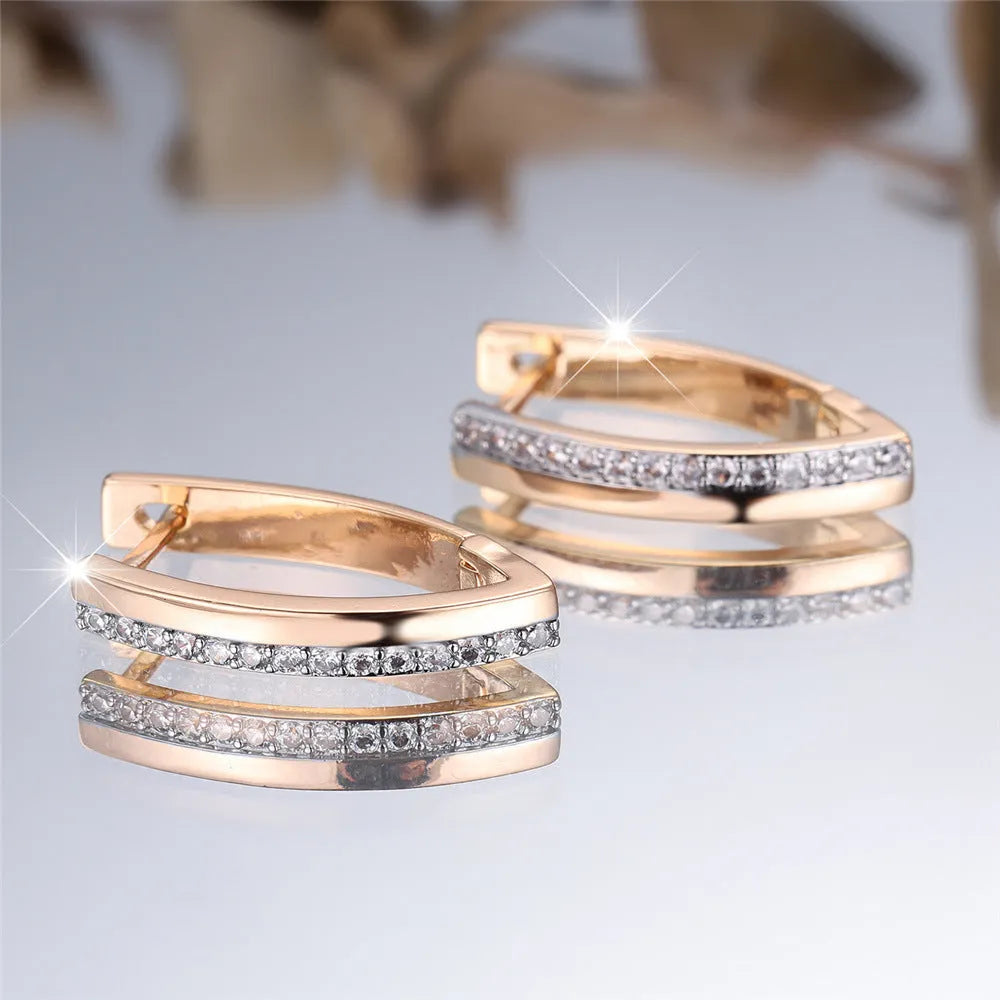 Geometric V-shaped women's ear clips in champagne gold with white diamond accents