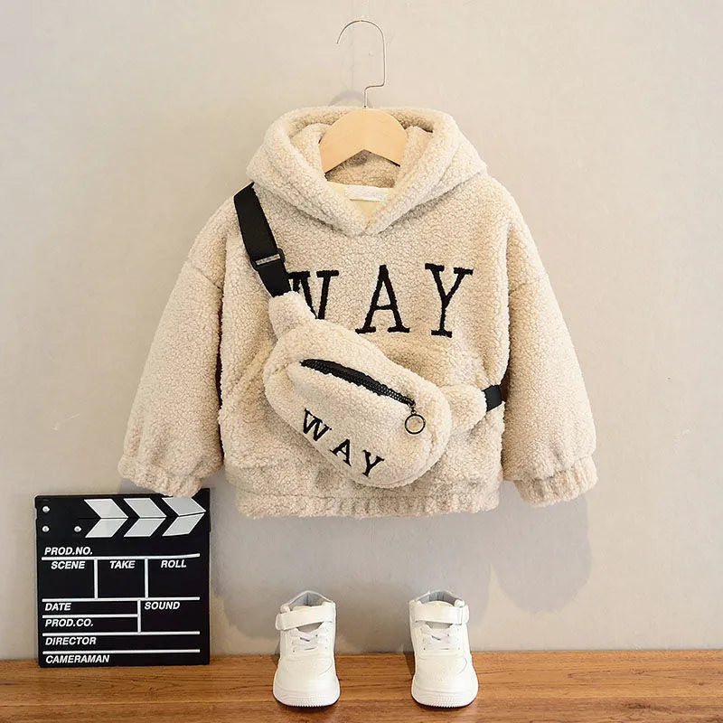 Child wearing a beige fleece hooded jacket with a cartoon print and long sleeves.