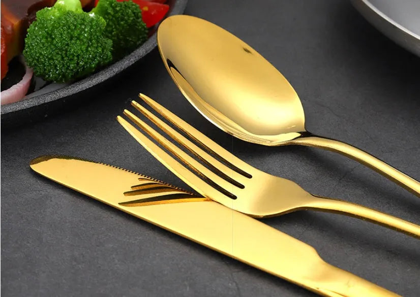 24-piece stainless steel cutlery set showing knives, forks, tablespoons and teaspoons in multiple finish colours
