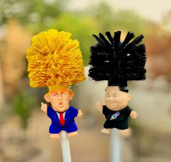 Yellow plastic Trump novelty toilet brush with a hanging slot on the handle.