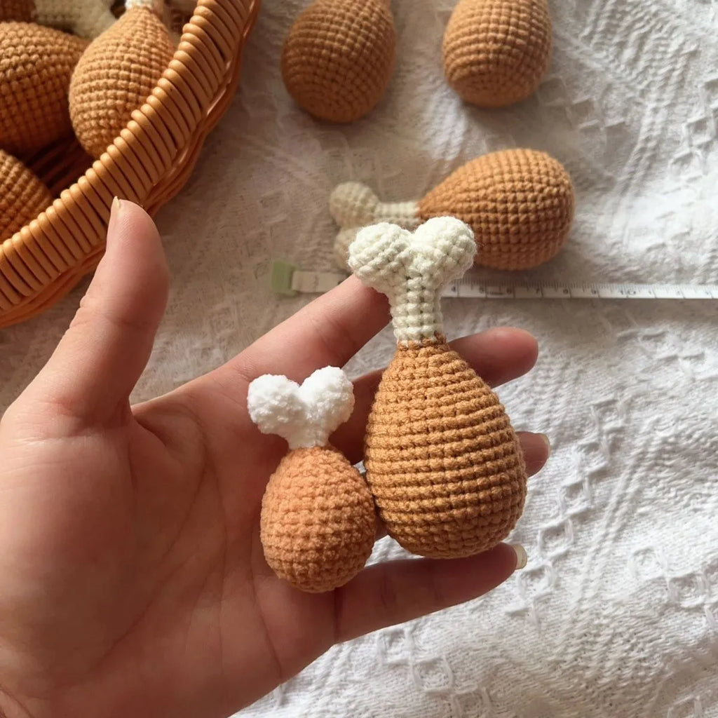 Hand-crocheted beige chicken leg keychain made from soft plush yarn on a metal ring.