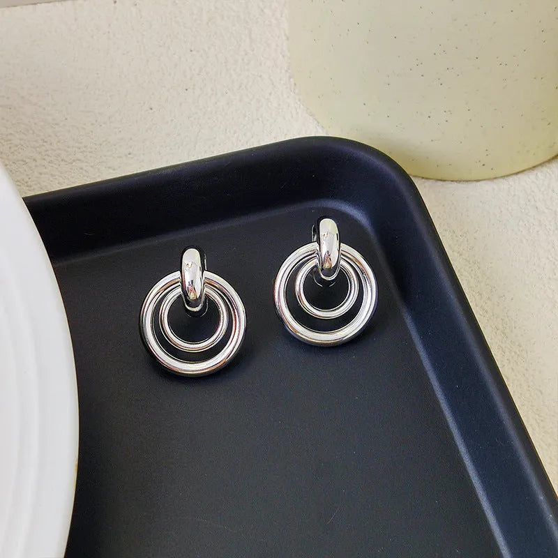 Geometric round ring earrings in gold or silver colour with irregular exotic styling