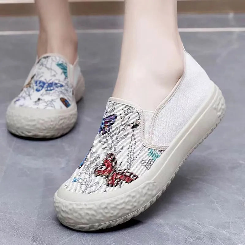 Women's black and white canvas slip-on shoes with round toe and decorative sewing thread details