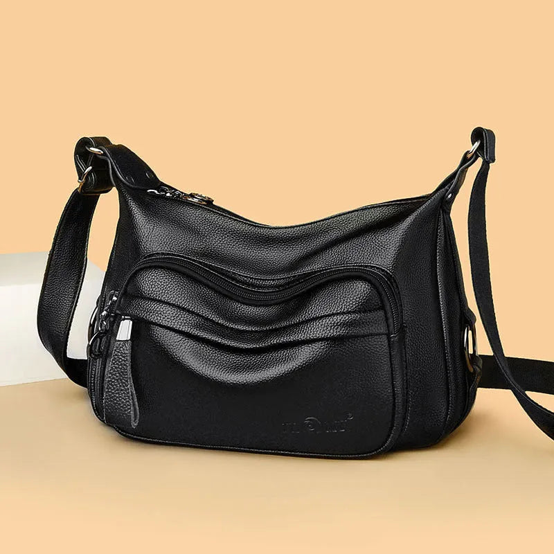 Large blue PU leather women's crossbody bag with zipper closure showing internal organiser pockets