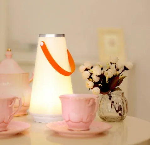White rechargeable LED bedside table lamp with a compact ABS plastic body and soft warm white glow.