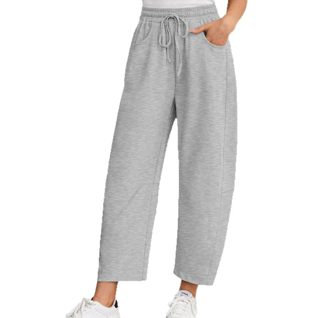 Loose sports cropped sweatpants in hot light grey with elastic waist and drawstring, showing collage/stitching craft details