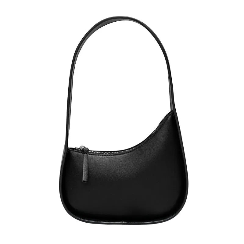 Leather ladies handbag in half-moon shape with wide shoulder strap and zipper opening