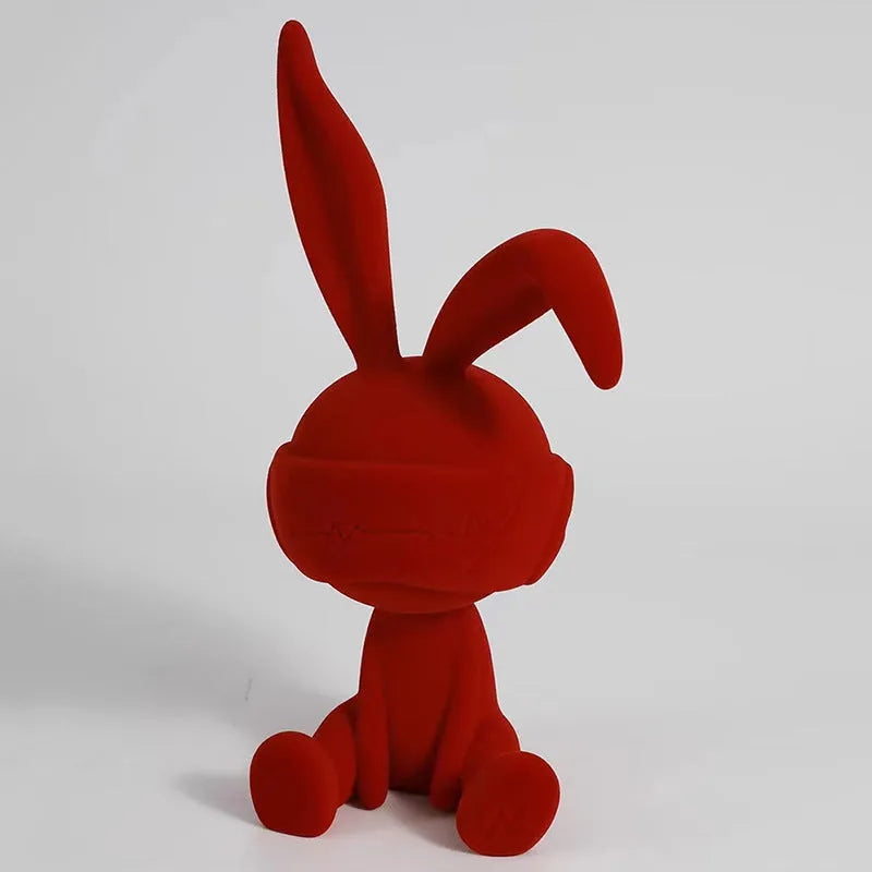 Green suede blindfold rabbit resin ornament on a wooden table, 15cm tall