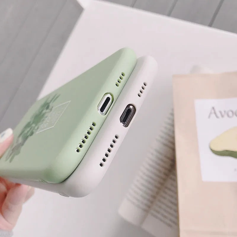 White silicone iPhone case with a detailed painted leaf and plant pattern on the back.