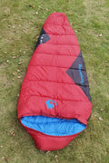 Mummy-style camping sleeping bag in Army Green colour, compressed in storage bag beside expanded view showing tapered design