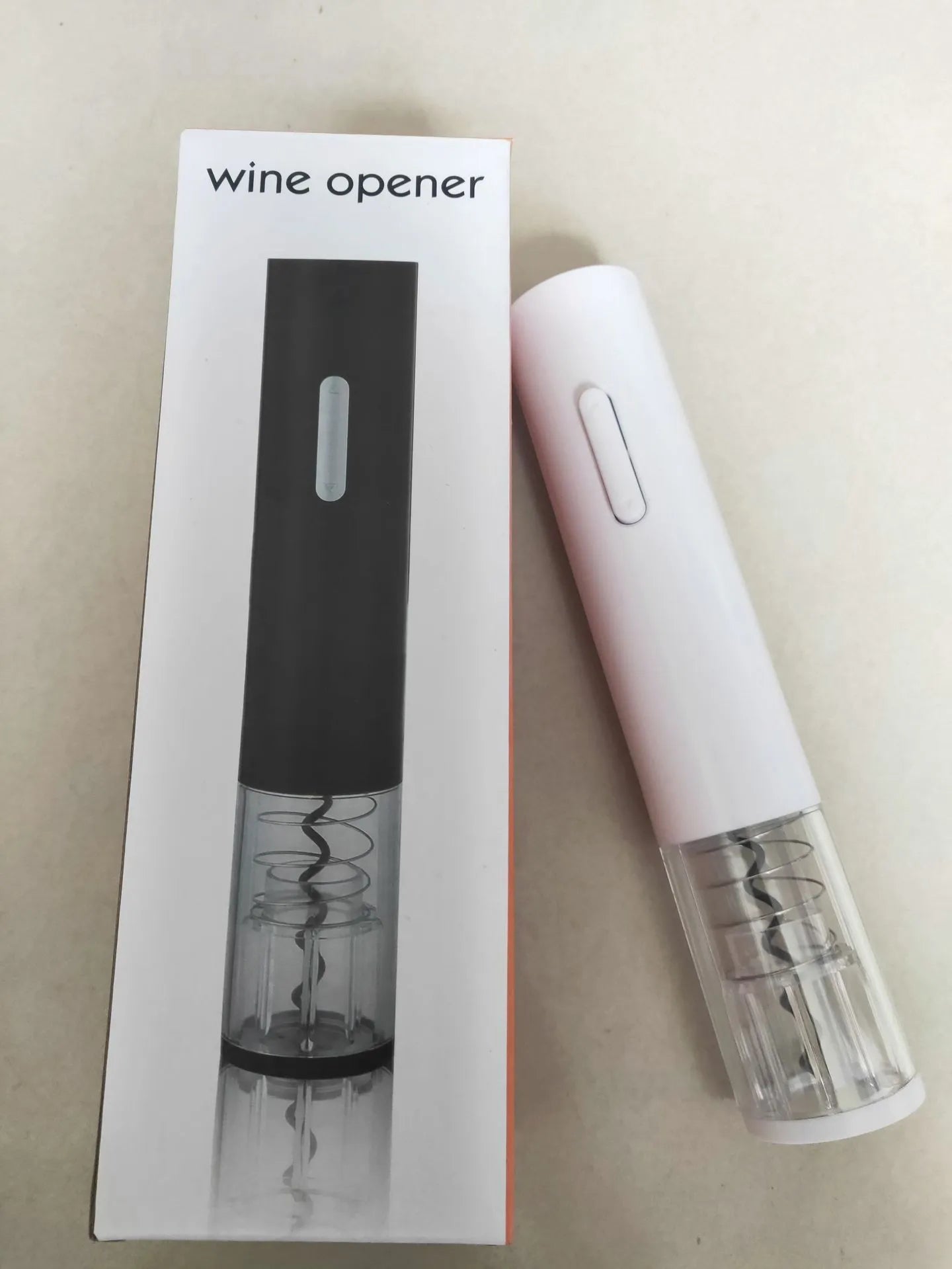 Black automatic electric wine bottle opener with foil cutter on a kitchen counter.